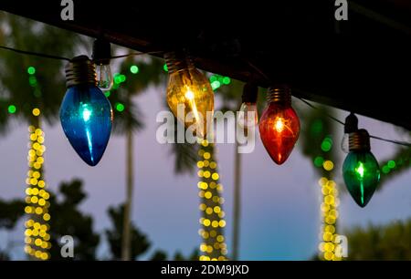 Weihnachtsbeleuchtung entlang Dachlinie mit Licht auf Bäumen in aufgereiht Hintergrund Stockfoto