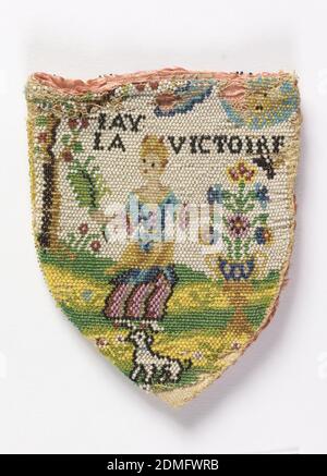 Purse, Medium: silk, glass beads Technique: looping incorporating strung beads. Two panels worked separately., Looped bag with solid beadwork. Design shows a woman with bouquet in pastoral setting, with 'Jay La Victoire' above her head. On other side of bag, two cupids by a stream with illegible (damaged) inscription in French (Se Trouvent Ris). Lined with pink silk damask, probably of later date., France, 18th century, costume & accessories, Purse Stock Photo