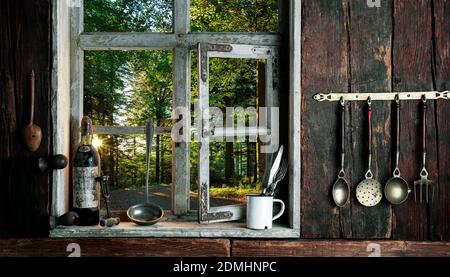 rustic farmer's kitchen with a view of the landscape through a wooden window Stock Photo