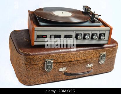 Vinyl player on an old leather suitcase isolated on a white background Stockfoto