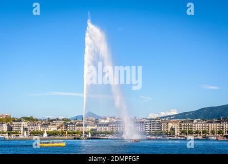 The bay of Geneva with the Jet d'Eau water jet fountain and a Mouettes Genevoises water bus. Stock Photo