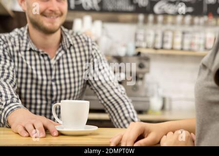 Cropped shot of a barista serving coffee to a female client at the local caffee shop positivity lifestyle urban cafe breakfast morning drink beverage Stockfoto