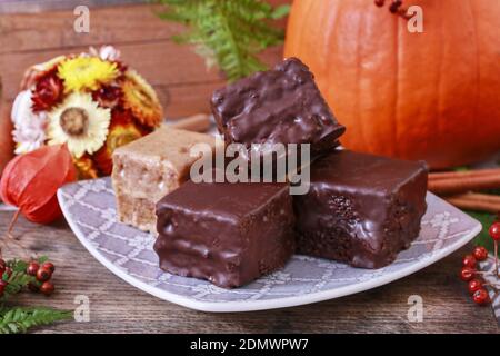 Gingerbread cubes in chocolate, sweet dessert, homemade cake. Stock Photo