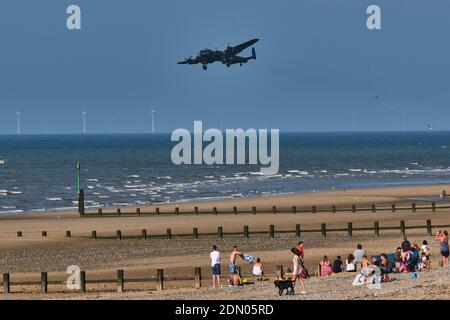 Der Avro Lancaster of the Battle of Britain Memorial Flight führt bei der Rhyl Air Show 2019 einen tiefen Pass über den Strand. Stockfoto