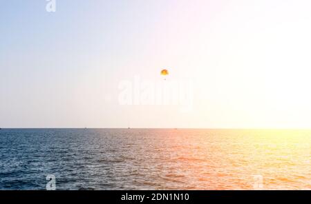 Parasailing wing pulled by boat, summer sunny activities at sea. Recreation outdoors. copyspace Stock Photo