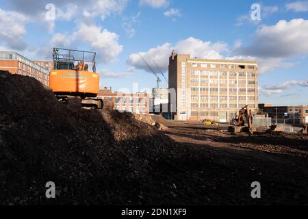 Die Bagger haben am 26. November 2020 in Birmingham, Großbritannien, die Arbeit an der Räumung eines großen Geländes und der Verlegung eines Ziegelstapels im Rahmen einer Erschließung/Sanierung alter Industriegebäude im Stadtzentrum zum Stillstand gebracht. Die Stadt befindet sich im Rahmen einer langfristigen und umfassenden Sanierung, wobei ein Großteil ihrer industriellen Vergangenheit im Rahmen des Big City Plans abgerissen und in neue Wohnungen für Wohnhäuser umgewandelt wird. Stockfoto