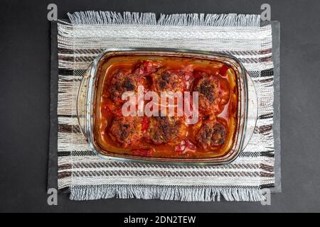 Meatballs baked in form in the oven with a gravy of tomato paste, tomatoes, onions and spices. Stock Photo