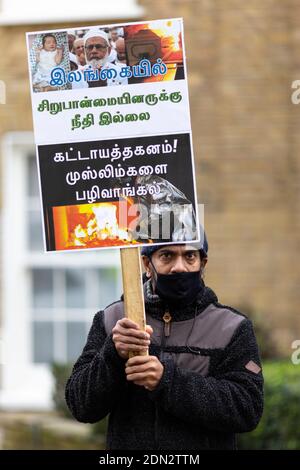 Protester with placard during protest against forced cremation of COVID-19 victims in Sri Lanka, Embassy of Sri Lanka, London, 12 December 2020 Stock Photo