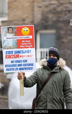 Protester with placard during protest against forced cremation of COVID-19 victims in Sri Lanka, Embassy of Sri Lanka, London, 12 December 2020 Stock Photo