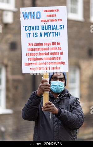 Protester with placard during protest against forced cremation of COVID-19 victims in Sri Lanka, Embassy of Sri Lanka, London, 12 December 2020 Stock Photo