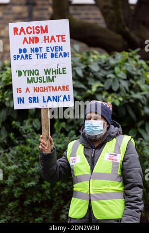 Protester with placard during protest against forced cremation of COVID-19 victims in Sri Lanka, Embassy of Sri Lanka, London, 12 December 2020 Stock Photo