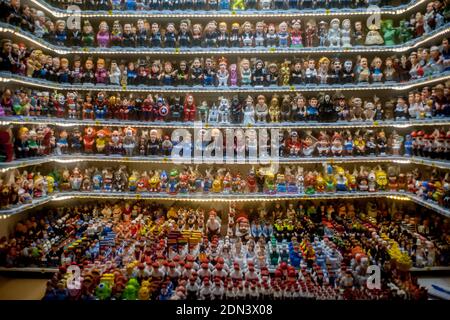 Catalan typical ceramic figurines known as 'caganers' are seen in a stall of Santa Llucia Christmas market in Barcelona. The caganers represent well-known characters in public life, from politicians to footballers, and are part of the typical Catalan crib. Stock Photo