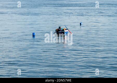 Setubal, Portugal - 17 December, 2020: fisherman checking his traps and catching octopus near Setubal on the Sado River Estuary Stock Photo