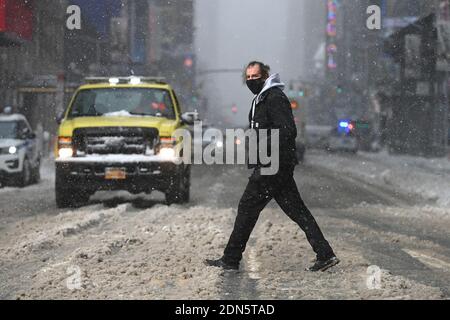 New York, USA. Dezember 2020. Ein Mann geht durch fallenden Schnee, als er 42nd Street während des ersten Wintersturms der Saison überquert, der mehr als einen Fuß Schnee in Teilen der Stadt, New York, NY, 17. Dezember 2020 hinterließ. Die Nor'easter links Teile des Upstate New York bedeckt mit etwa 40 Zoll Schnee, während andere Teile des Nordostens sah weniger als zwei Fuß, sondern links Straßen glatt und gefährlich für Fahrer, und den Flugverkehr gestoppt, einschließlich der geplanten Lieferungen des Pfizer-BioNTech COVID-19-Impfstoff. (Foto von Anthony Behar/Sipa USA) Quelle: SIPA USA/Alamy Live News Stockfoto