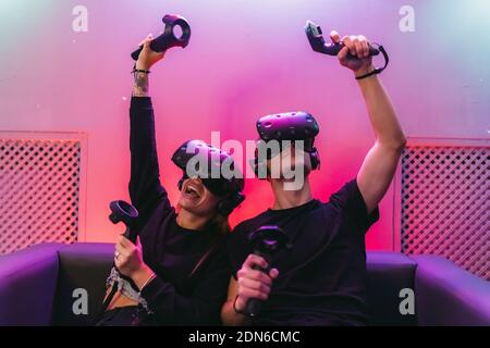 VR Battle on the couch. People spend time in the game. Stock Photo