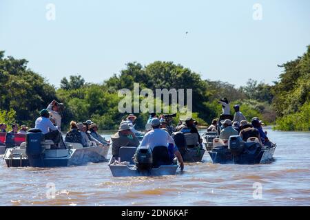 Tourists on boats looking for jaguars on the Três Irmãos River, Pantanal of Mato Grosso, Brazil Stock Photo