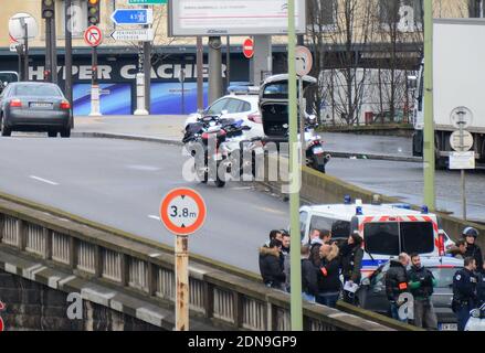 Police forces gather nearby Porte de Vincennes, east of Paris, after at least one person was injured when a gunman opened fire at a kosher grocery store on January 9, 2015 and took at least five people hostage. The attacker was suspected of being the same gunman who killed a policewoman in a shooting in Montrouge in southern Paris, France on January 8. Photo by Nicolas Briquet/ABACAPRESS.COM Stock Photo