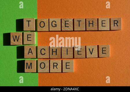 Team, Together We Achieve More, words in wooden alphabet letters isolated on colourful background Stock Photo