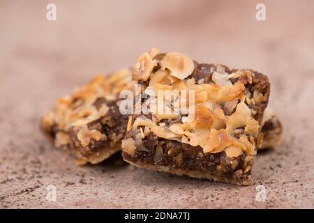 Confectioneries with nuts and chocolate, german christmas sweets, little cakes on a brown textured background, empty copy space for text Stockfoto