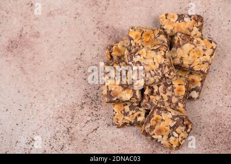 Confectioneries with nuts and chocolate, german christmas sweets, little cakes on a brown textured background, empty copy space for text Stockfoto
