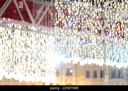 Christmas street lighting bright yellow defocused bokeh lights Christmas festive Winter holidays celebration background in city of Kyiv, Ukraine. Stock Photo