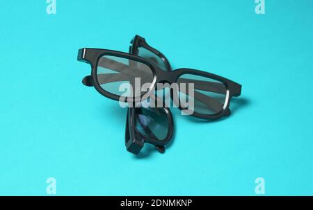 Two pairs of 3d glasses on blue background. Top view. Minimalism Stock Photo
