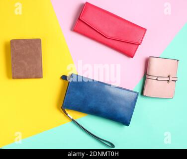 Many leather purses on a colored pastel background. Top View Stock Photo