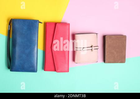 Many leather purses on a colored pastel background. Top View Stock Photo