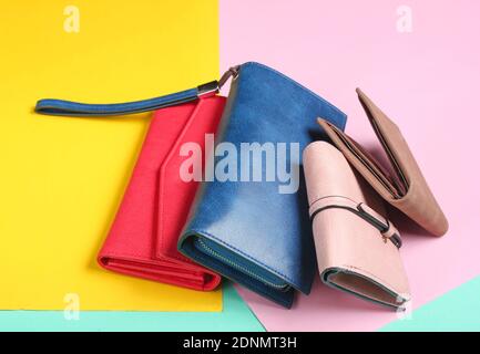 Many leather purses on a colored pastel background. Top View Stock Photo