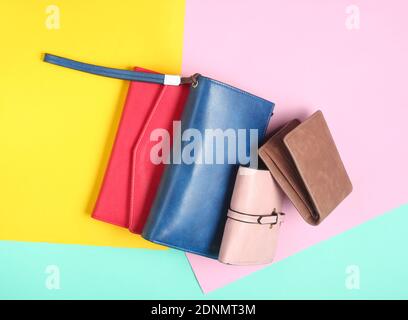 Many leather purses on a colored pastel background. Top View Stock Photo