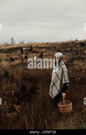 Woman carrying wicker basket Stock Photo