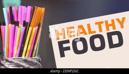 Colorful drinking straws and card with text Healthy Food. Small business concept . Healthcare concept. Stock Photo