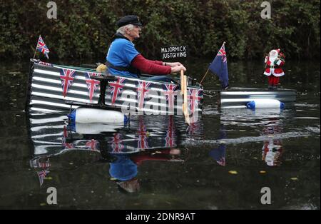 Michael Stanley, bekannt als 'Major Mick', macht seinen Weg entlang des Chichester Kanals, als er seine 70 Meilen Ruderherausforderung in seinem selbstgemachten Boot Tintanic, in Hilfe von St Wilfrid's Hospiz in Bosham beendet. Stockfoto