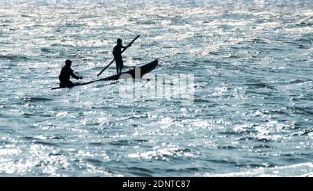 Silhouette von zwei Fischern in einem Fischerboot bei Sonnenaufgang, Sri Lanka Stockfoto