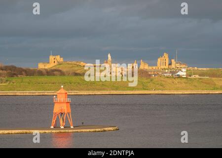 Die Herde Groyne Leuchtturm und Tynemouth Burg und Priorat Gebäude von South Shields, Nordostengland, Großbritannien gesehen Stockfoto