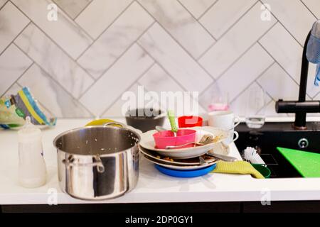 Dirty dishes on kitchen worktop Stock Photo