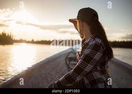 Woman on boat looking at lake Stock Photo