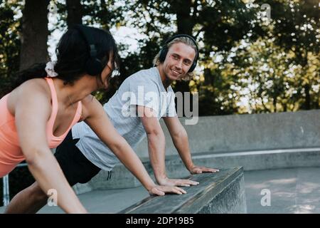 Couple doing push-ups together Stock Photo