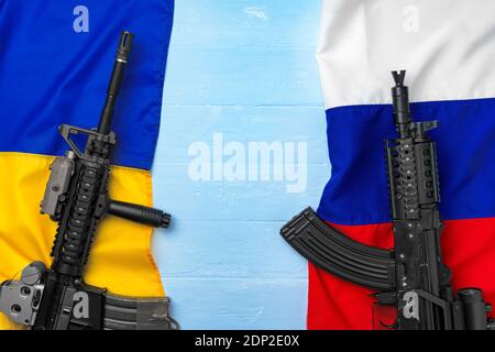 Flaggen Russlands und der Ukraine mit Waffengewehren Stockfoto
