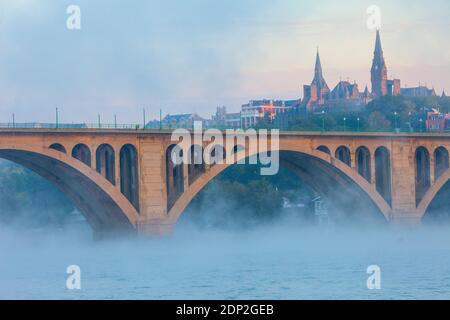 Key Bridge over the Potomac River in Early Morning Fog, Looking toward Georgetown University on right, Washington DC, USA. Stock Photo