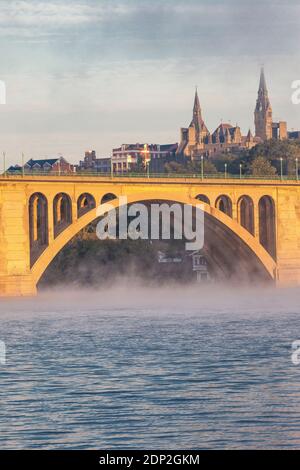 Key Bridge over the Potomac River in Early Morning Fog, Looking toward Georgetown University on right, Washington DC, USA. Stock Photo