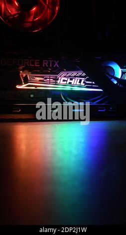 Aufnahme im vertikalen Format mit bunt verschwommenem Vordergrund für den Kopierbereich. Gaming-PC-Tower mit NVIDIA GeForce RTX 3080 Grafikkarte und farbenfrohem Backligh Stockfoto