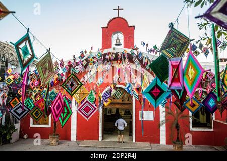 The main church in Sayulita, Nayarit, Mexico decorated outside with Ojo de Dios or 'God's Eye', a local symbol and craft of the indigenous Huichol cul Stock Photo