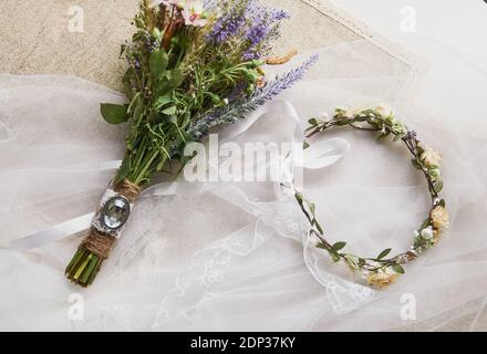 Zarte Hochzeitskranz in Boho-Stil auf dem Tisch bedeckt Mit einem Hochzeitsschleier Stockfoto