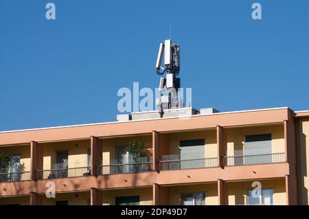 Blick auf eine Telecommunication Tower-Antenne des 4G- und 5G-Mobilfunksystems auf einem Gebäude in der Stadt Sorengo, Schweiz Stockfoto
