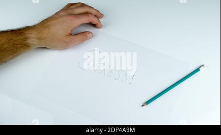 Poster mit dem Wort Stress auf a4-Papier, einem Bleistift auf dem Desktop und dem Wort Stress. Stockfoto