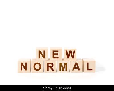 NEUER NORMALER Text auf Holzwürfel. Nahaufnahme des neuen normalen Textes auf weißem Hintergrund Stockfoto