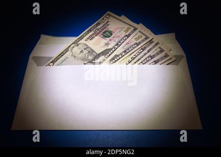 American Dollars in the Envelope on the Blue Paper Background Stockfoto
