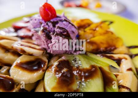 Eis, Obst und Schokoladensirup auf einer Waffel Stockfoto