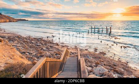 Blick auf Port Willunga Beach mit Pier Ruinen bei Sonnenuntergang, South Australia Stockfoto